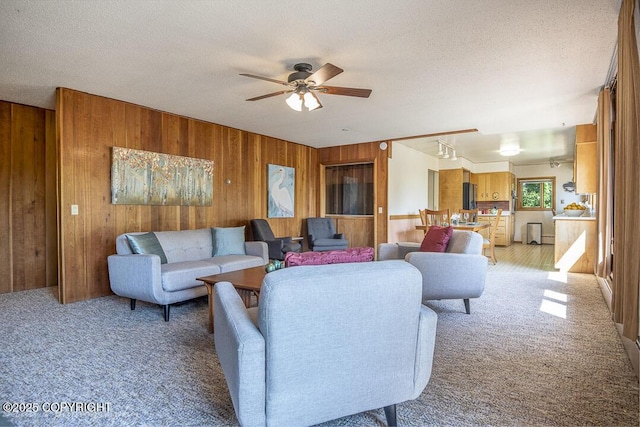 15021 Old Seward Hwy, Anchorage, AK 99516 - living area with wood walls, light colored carpet, ceiling fan, and a textured ceiling