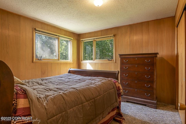 15021 Old Seward Hwy, Anchorage, AK 99516 - carpeted bedroom with wooden walls and a textured ceiling