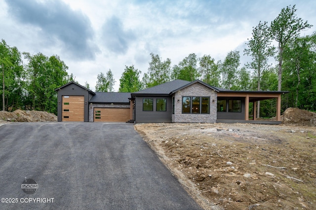 1770 S Corwin Ln, Wasilla, AK 99654 - contemporary home featuring asphalt driveway, an attached garage, and stone siding