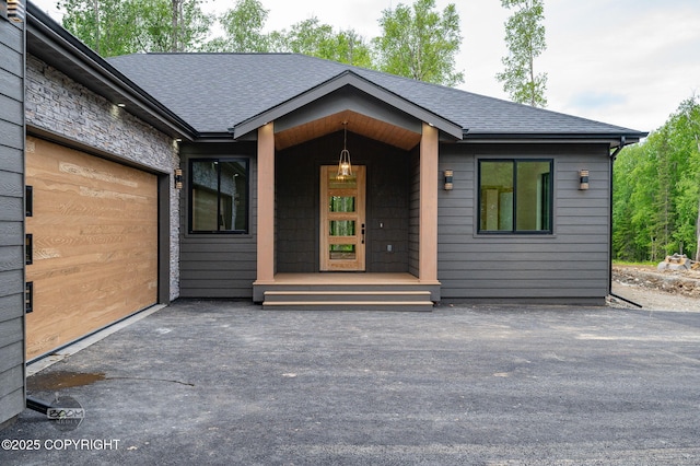 1770 S Corwin Ln, Wasilla, AK 99654 - entrance to property with roof with shingles, asphalt driveway, a garage, and a porch