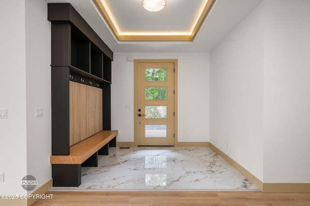 1770 S Corwin Ln, Wasilla, AK 99654 - mudroom featuring a tray ceiling and baseboards