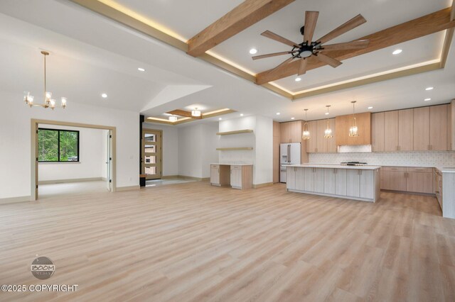 1770 S Corwin Ln, Wasilla, AK 99654 - unfurnished living room featuring recessed lighting, a tray ceiling, light wood-type flooring, ceiling fan, and a chandelier