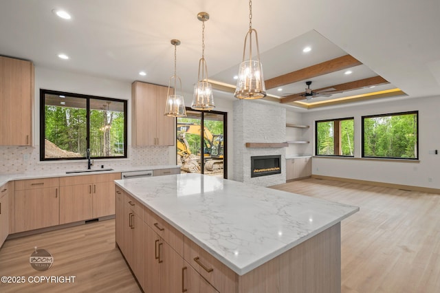 1770 S Corwin Ln, Wasilla, AK 99654 - kitchen with light brown cabinetry, light wood-style flooring, light stone countertops, ceiling fan, and recessed lighting