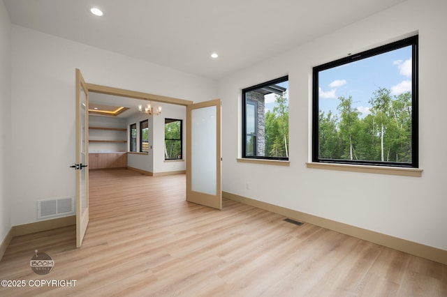 1770 S Corwin Ln, Wasilla, AK 99654 - empty room featuring light wood finished floors, a chandelier, and recessed lighting