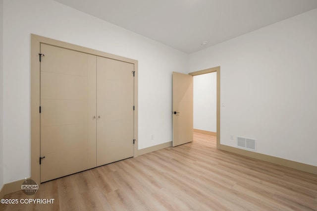 1770 S Corwin Ln, Wasilla, AK 99654 - unfurnished bedroom featuring light wood-style floors and a closet