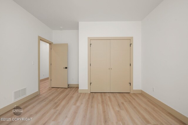 1770 S Corwin Ln, Wasilla, AK 99654 - unfurnished bedroom featuring light wood-style floors and a closet