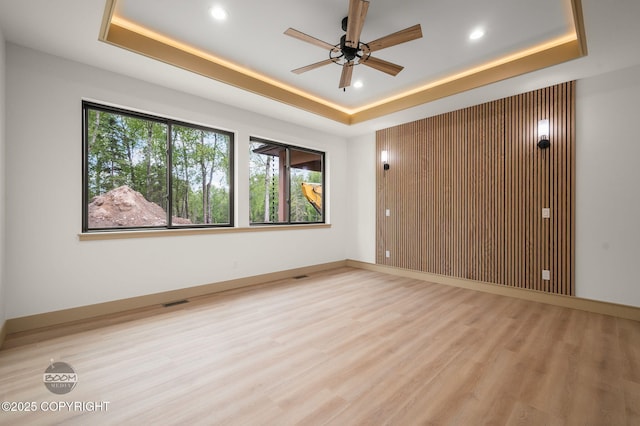 1770 S Corwin Ln, Wasilla, AK 99654 - unfurnished room with a tray ceiling, wood finished floors, ceiling fan, and recessed lighting