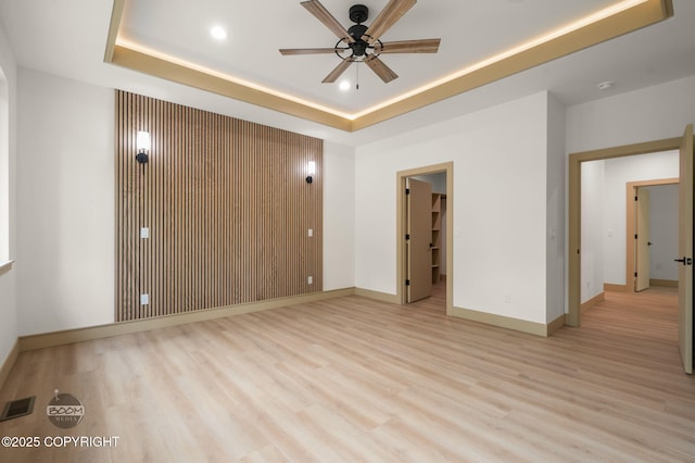 1770 S Corwin Ln, Wasilla, AK 99654 - spare room featuring a tray ceiling, ceiling fan, light wood finished floors, and recessed lighting