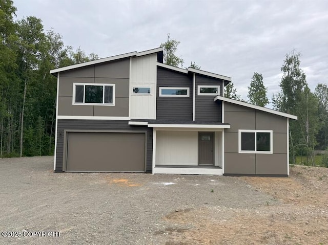 7075 S Brimstone Dr, Wasilla, AK 99623 - contemporary house featuring gravel driveway and an attached garage