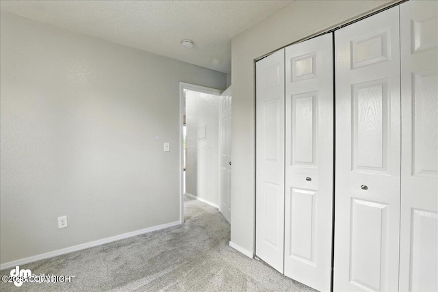 8203 Duben Ave, Anchorage, AK 99504 - unfurnished bedroom featuring light colored carpet and a closet