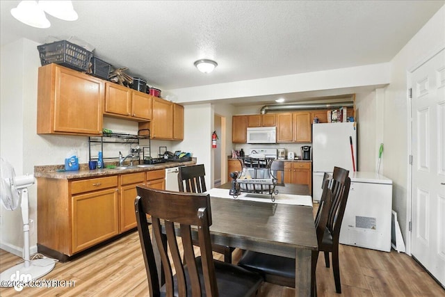 8203 Duben Ave, Anchorage, AK 99504 - dining room featuring light wood-style floors and a textured ceiling