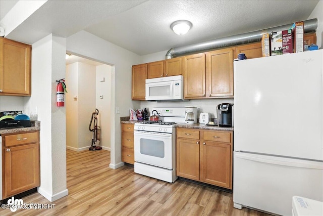 8203 Duben Ave, Anchorage, AK 99504 - kitchen with white appliances and light wood finished floors