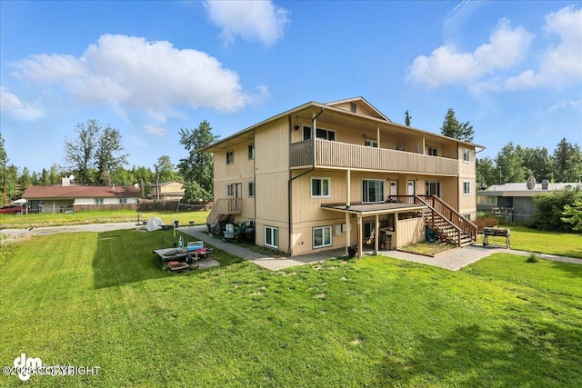 8203 Duben Ave, Anchorage, AK 99504 - rear view of property featuring stairway, a patio area, and a balcony
