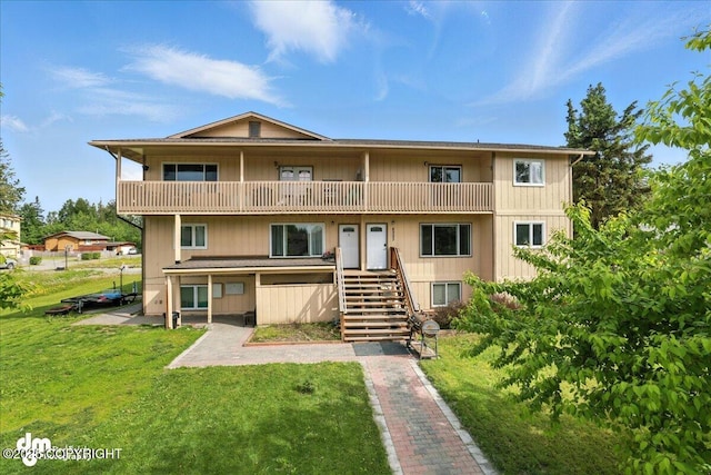 8203 Duben Ave, Anchorage, AK 99504 - back of house featuring a balcony, stairs, and a yard