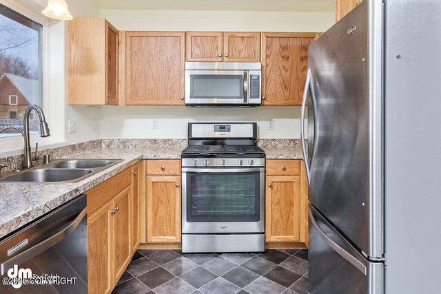 3900 N Mirmar St, Wasilla, AK 99623 - kitchen with appliances with stainless steel finishes, light countertops, and dark tile patterned floors