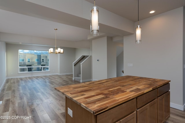 3680 Little Bear Pl Unit 8, Anchorage, AK 99504 - kitchen with butcher block countertops, light wood finished floors, open floor plan, a chandelier, and recessed lighting