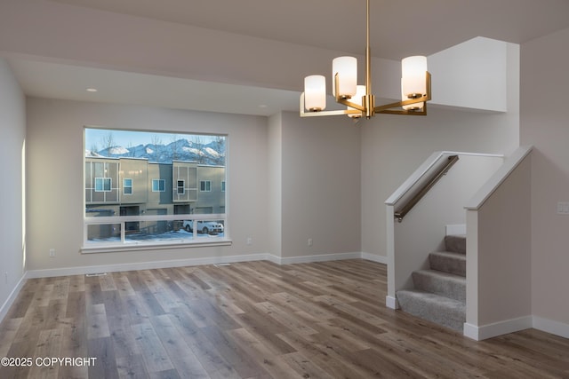 3680 Little Bear Pl Unit 8, Anchorage, AK 99504 - empty room with a chandelier, wood finished floors, and stairway