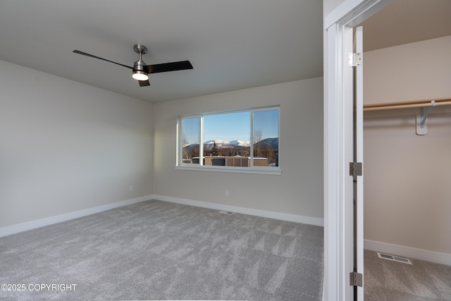 3680 Little Bear Pl Unit 8, Anchorage, AK 99504 - unfurnished bedroom featuring carpet, ceiling fan, a walk in closet, and a closet