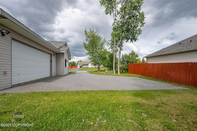 230 W Fallen Leaf Cir, Wasilla, AK 99654 - view of yard with asphalt driveway and an attached garage
