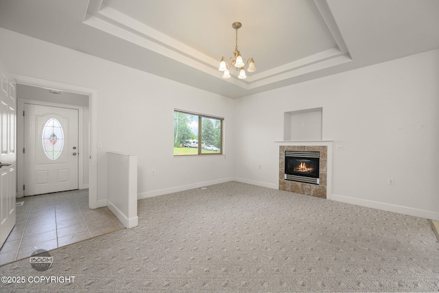 230 W Fallen Leaf Cir, Wasilla, AK 99654 - unfurnished living room with a chandelier, plenty of natural light, a tray ceiling, and carpet floors