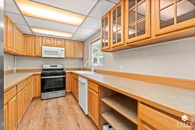 13440 Diggins Dr, Anchorage, AK 99515 - kitchen with white appliances, light wood-type flooring, light countertops, glass insert cabinets, and tasteful backsplash