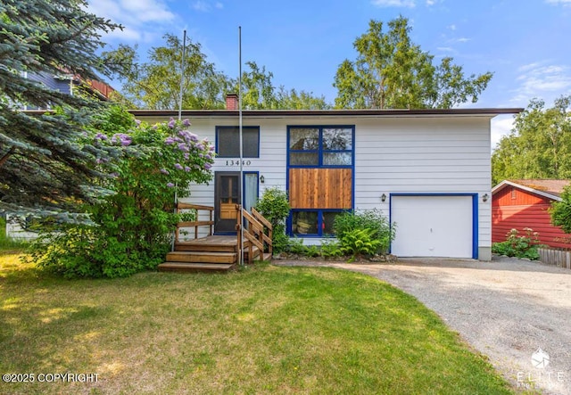 13440 Diggins Dr, Anchorage, AK 99515 - view of front of property featuring asphalt driveway, a front yard, a chimney, and a garage