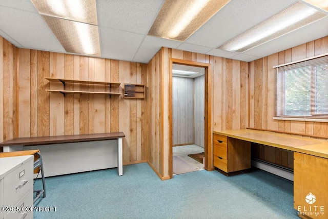13440 Diggins Dr, Anchorage, AK 99515 - unfurnished office with a baseboard radiator, carpet floors, wood walls, and built in desk