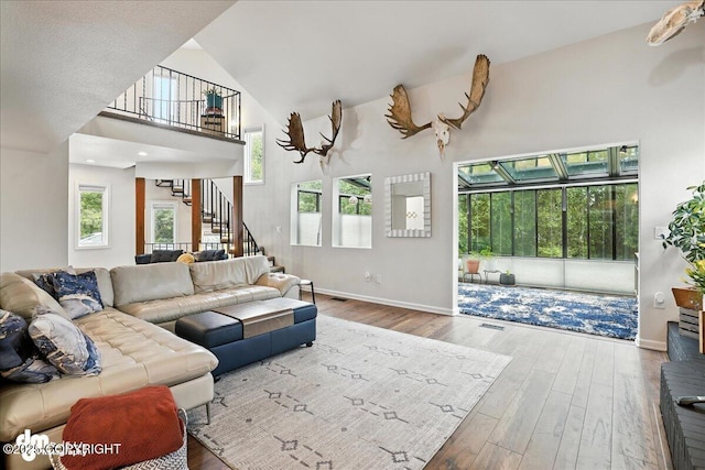 1535 M St, Anchorage, AK 99501 - living area with a high ceiling, stairs, and hardwood / wood-style floors