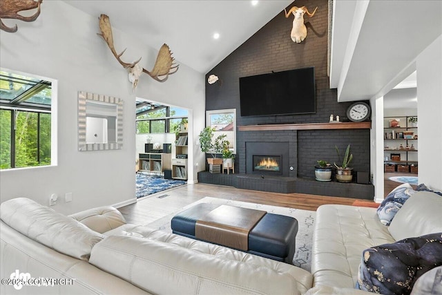 1535 M St, Anchorage, AK 99501 - living room with high vaulted ceiling, wood finished floors, plenty of natural light, a fireplace, and recessed lighting