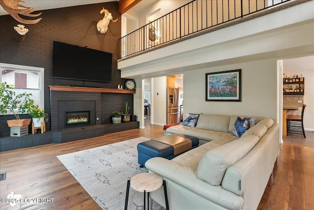 1535 M St, Anchorage, AK 99501 - living room with a towering ceiling, wood-type flooring, and a fireplace
