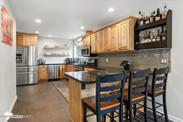 1535 M St, Anchorage, AK 99501 - kitchen featuring appliances with stainless steel finishes, open shelves, dark countertops, tasteful backsplash, and a peninsula