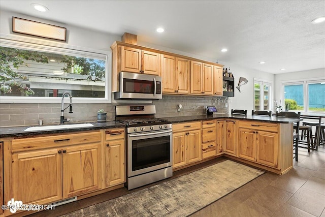 1535 M St, Anchorage, AK 99501 - kitchen with stainless steel appliances, decorative backsplash, a peninsula, recessed lighting, and open shelves