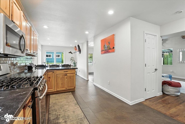 1535 M St, Anchorage, AK 99501 - kitchen with appliances with stainless steel finishes, a peninsula, and recessed lighting
