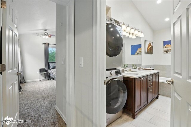 1535 M St, Anchorage, AK 99501 - laundry area with estacked washer and dryer, ceiling fan, light carpet, and recessed lighting