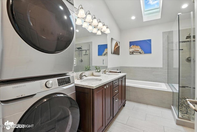 1535 M St, Anchorage, AK 99501 - full bathroom featuring a skylight, stacked washer and clothes dryer, a bath, a stall shower, and recessed lighting