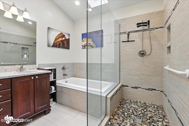 1535 M St, Anchorage, AK 99501 - full bathroom featuring a tile shower, a garden tub, vanity, recessed lighting, and a skylight