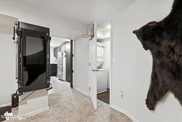 1535 M St, Anchorage, AK 99501 - hallway featuring estacked washer and dryer and carpet flooring