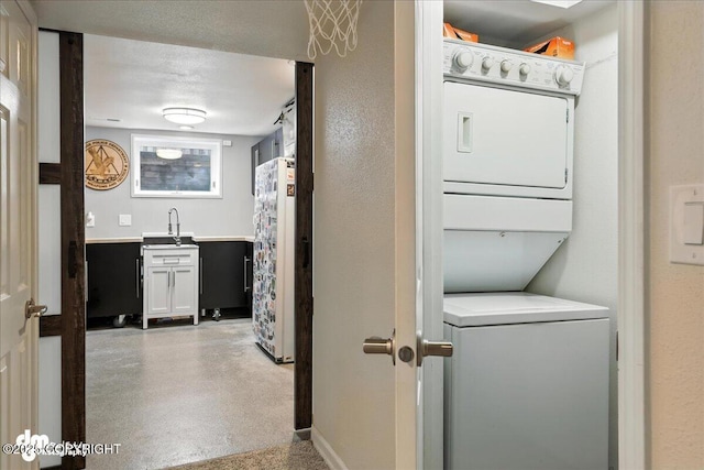1535 M St, Anchorage, AK 99501 - washroom with stacked washer / drying machine and baseboards