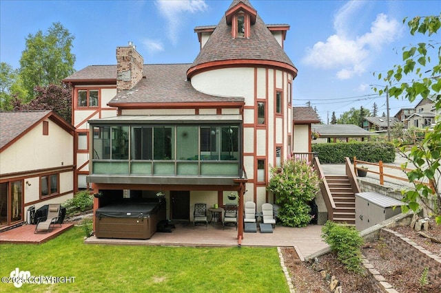 1535 M St, Anchorage, AK 99501 - back of property with a hot tub, stucco siding, a sunroom, a wooden deck, and stairs