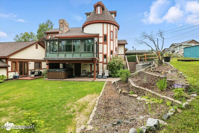 1535 M St, Anchorage, AK 99501 - rear view of house with a hot tub, a sunroom, a patio area, and a lawn