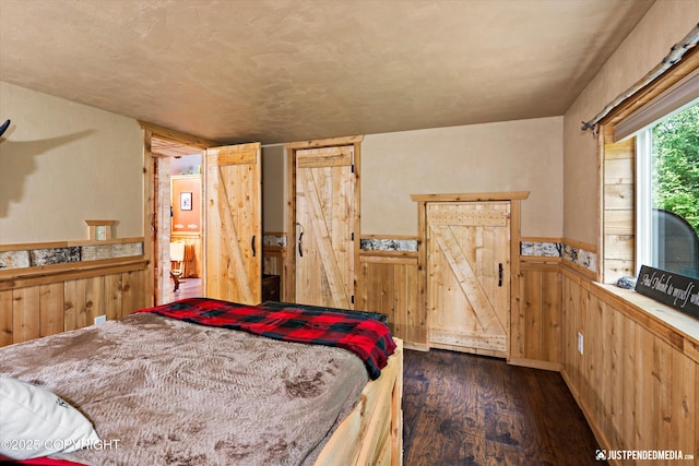 29416 W Deshka Landing Rd, Willow, AK 99688 - bedroom with dark wood-style flooring, a wainscoted wall, and wooden walls