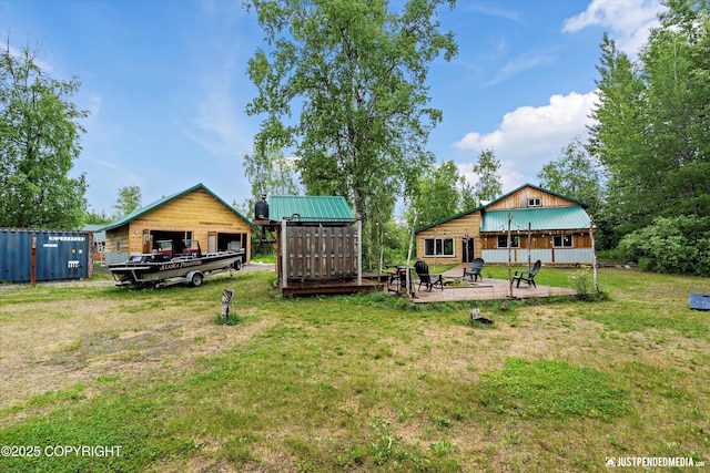 29416 W Deshka Landing Rd, Willow, AK 99688 - view of grassy yard with a patio, an outbuilding, a detached garage, and a pole building