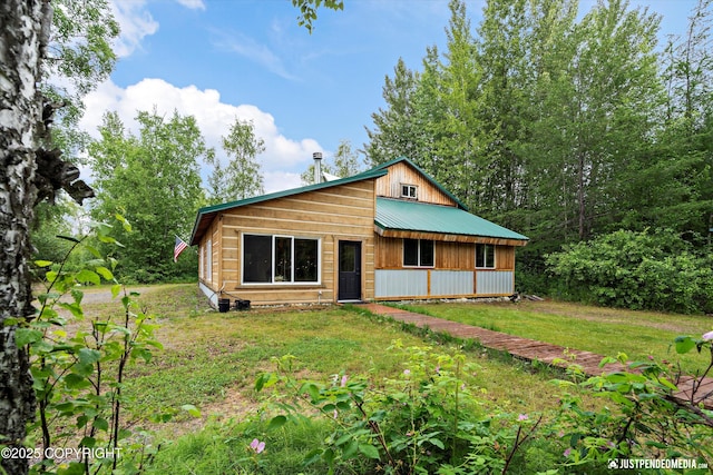 29416 W Deshka Landing Rd, Willow, AK 99688 - rustic home featuring a metal roof and a front lawn