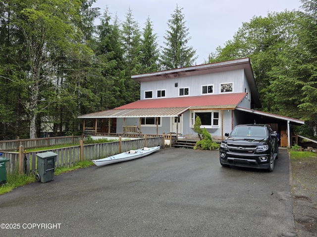 297 Mitkof Hwy, Petersburg, AK 99833 - view of front of house with driveway, a metal roof, and a carport
