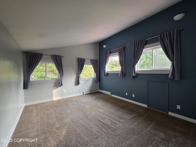 297 Mitkof Hwy, Petersburg, AK 99833 - carpeted empty room featuring healthy amount of natural light, vaulted ceiling, and a baseboard radiator