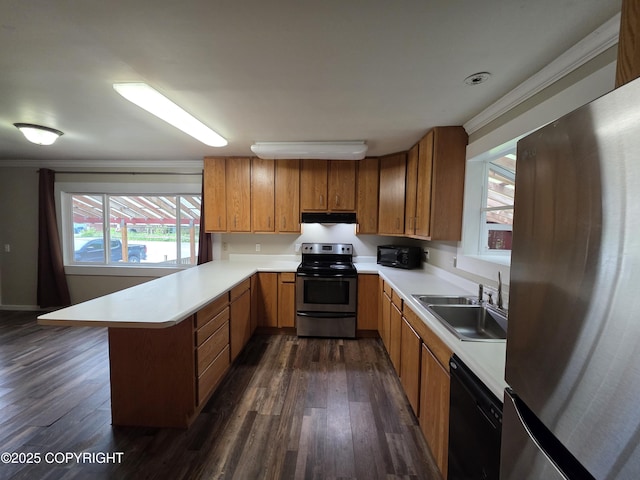 297 Mitkof Hwy, Petersburg, AK 99833 - kitchen with black appliances, a peninsula, under cabinet range hood, dark wood-style floors, and light countertops