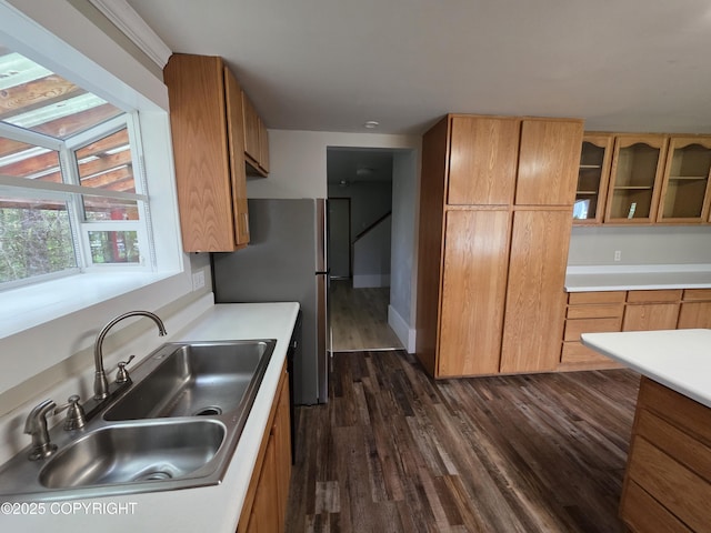297 Mitkof Hwy, Petersburg, AK 99833 - kitchen featuring dark wood-style flooring, freestanding refrigerator, light countertops, glass insert cabinets, and brown cabinets