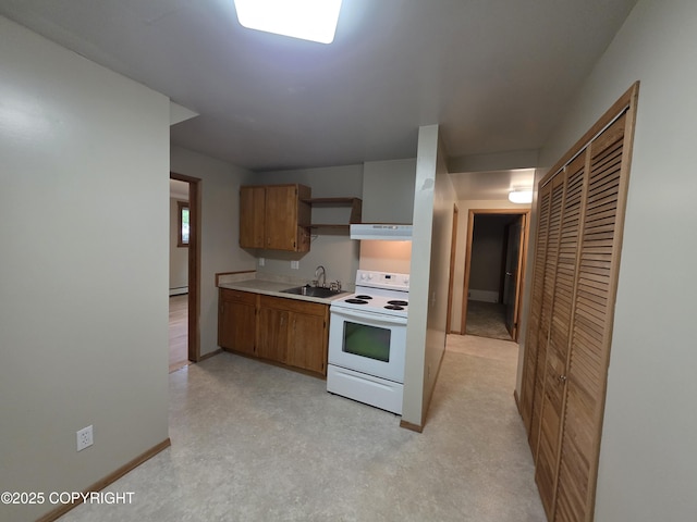 297 Mitkof Hwy, Petersburg, AK 99833 - kitchen featuring white electric range, under cabinet range hood, light countertops, brown cabinetry, and a baseboard radiator