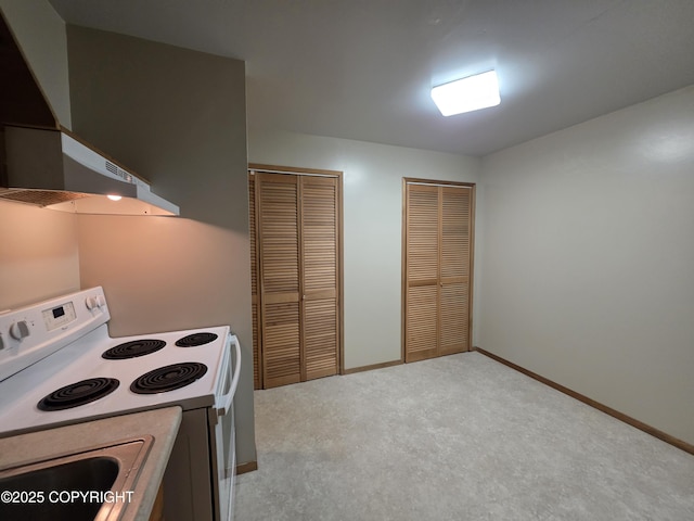 297 Mitkof Hwy, Petersburg, AK 99833 - kitchen with white range with electric stovetop, wall chimney exhaust hood, and carpet floors
