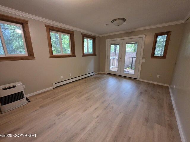 297 Mitkof Hwy, Petersburg, AK 99833 - unfurnished room with a baseboard radiator, french doors, light wood-style flooring, and crown molding
